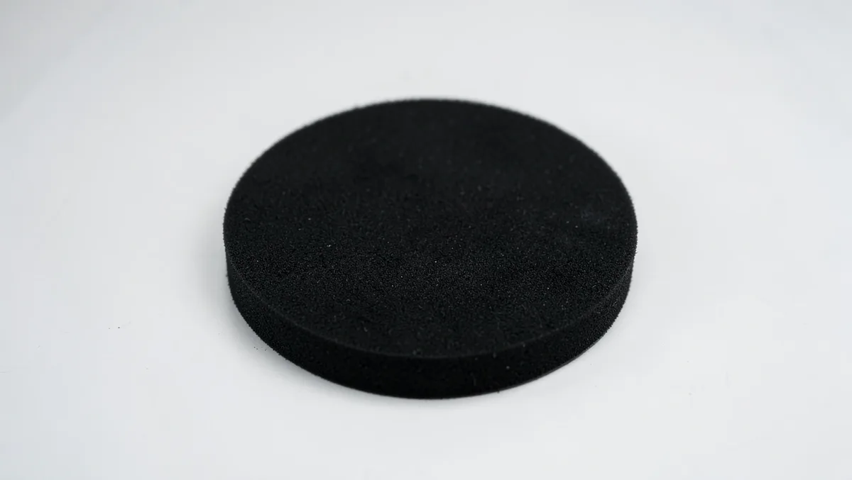 Flat black foam polishing pad used with a dual-action or rotary car buffer