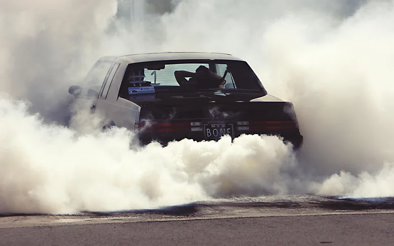 Rear tire smoke from a car breaking traction Rear tire smoke and burnout from a car breaking traction