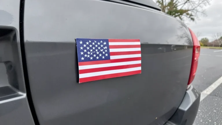 Flat American flag magnet mounted on the rear door panel of a gray SUV