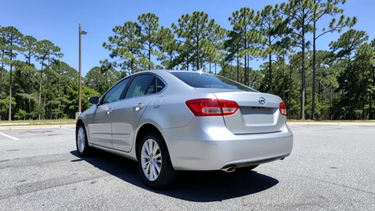 Silver rental sedan parked in a sunny lot in Georgia surrounded by tall pine trees