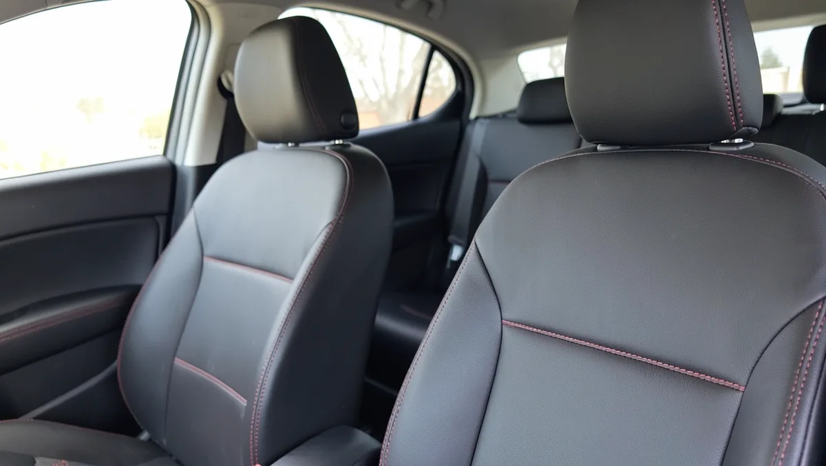 Black leather seat covers with red stitching installed in a Honda Civic front seats