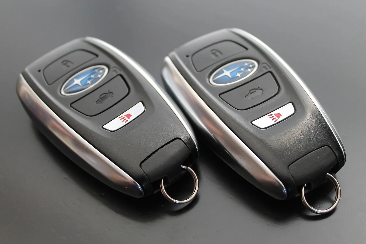 Two modern proximity smart key fobs with push-button controls Two modern proximity smart key fobs with push-button controls