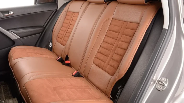 Clean tan leather and suede rear bench seat inside a car