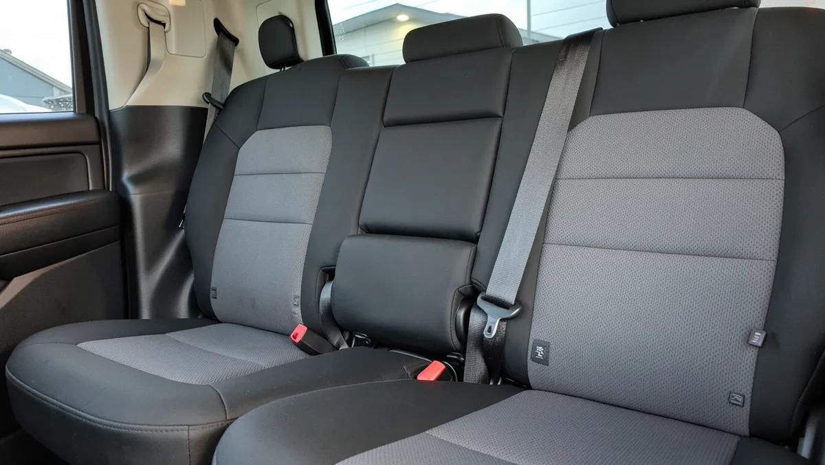 Toyota Tundra CrewMax rear bench seat with black and gray seat covers and folding armrest