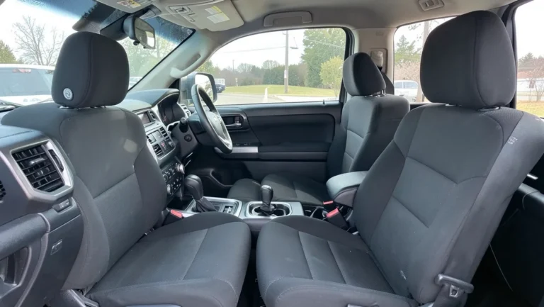 Toyota Tundra pickup truck front bucket seats fitted with seat covers, cab interior view