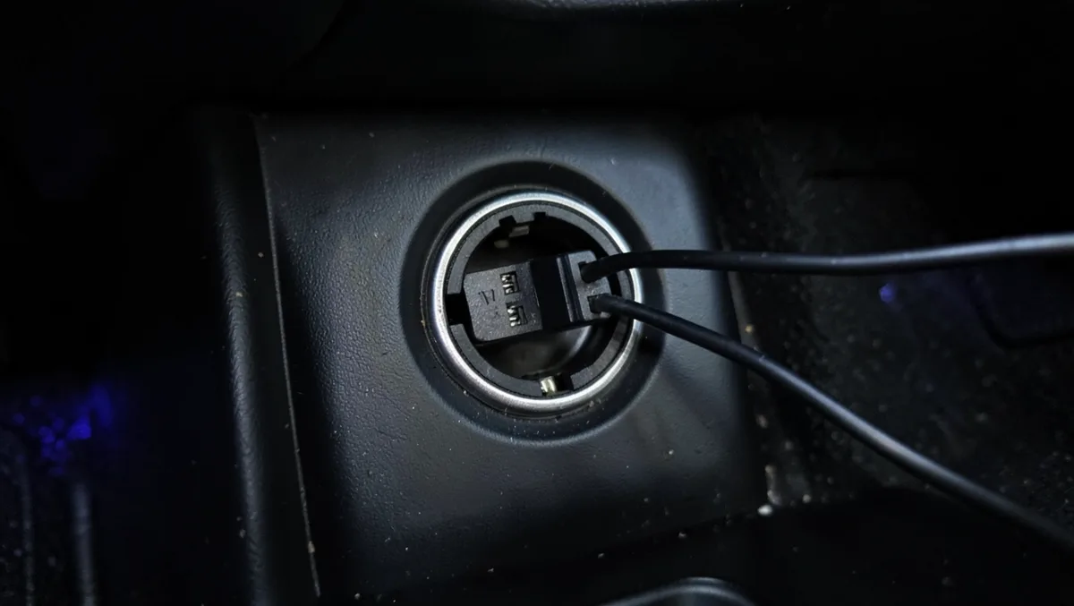 LED light strip power adapter plugged into a car 12V accessory socket