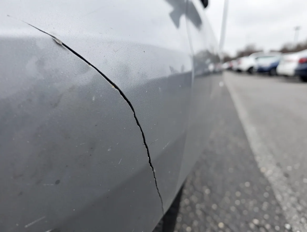 Cracked plastic bumper corner after a car collision