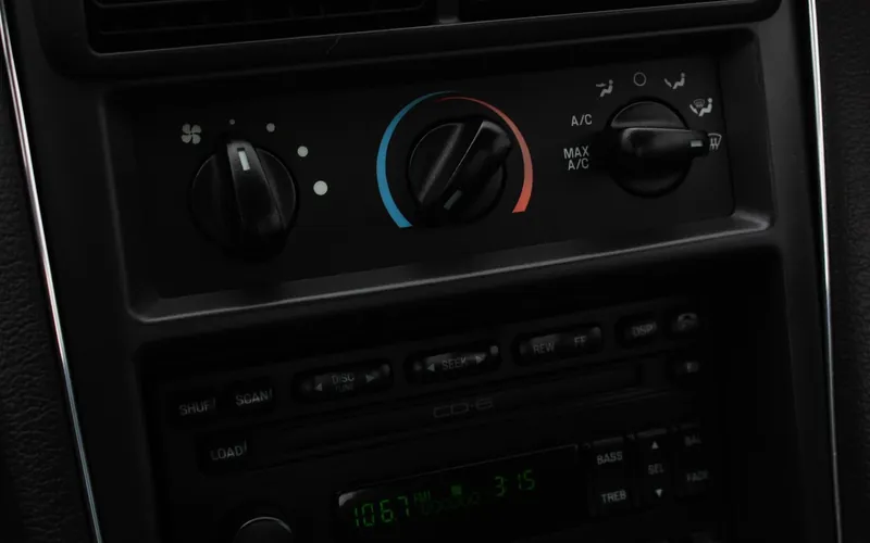 Manual climate control knobs with A/C and recirculation settings on a car dashboard
