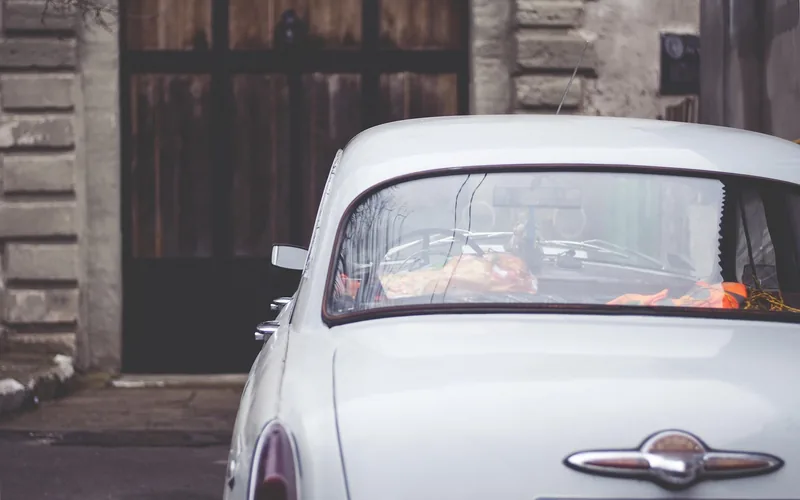 Rear window of a classic gray sedan seen from behind