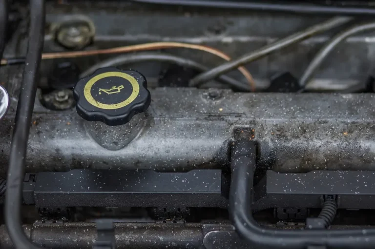 Engine oil filler cap with the oil can symbol on top of an engine
