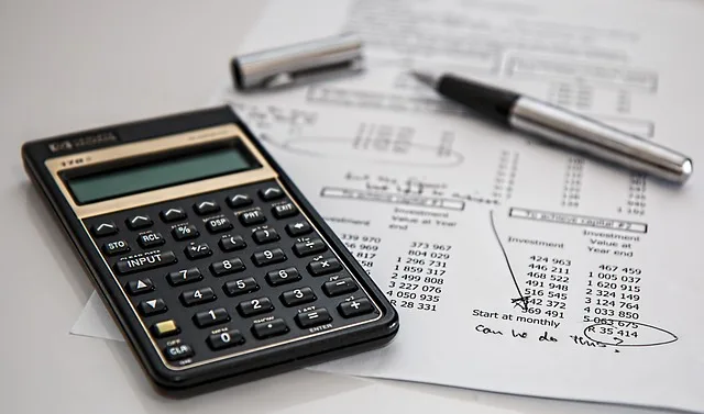 calculator and insurance policy paperwork used to check coverage limits