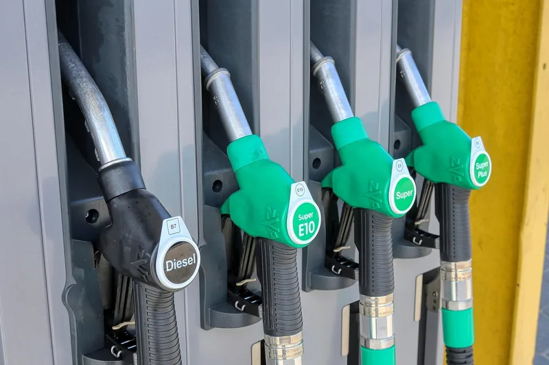 Fuel pump nozzles labeled Diesel, Super E10, Super, and Super Plus showing different fuel grades