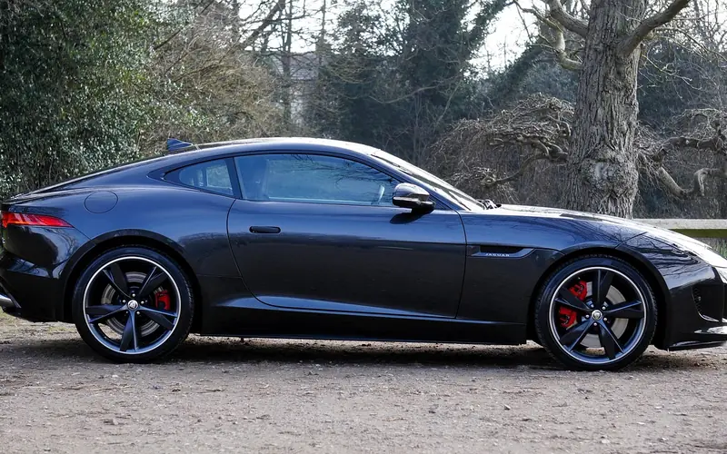 Dark Jaguar sports coupe seen from the side