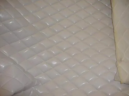 LUVFABRICS white diamond-quilted faux leather vinyl fabric with foam backing, folded sample