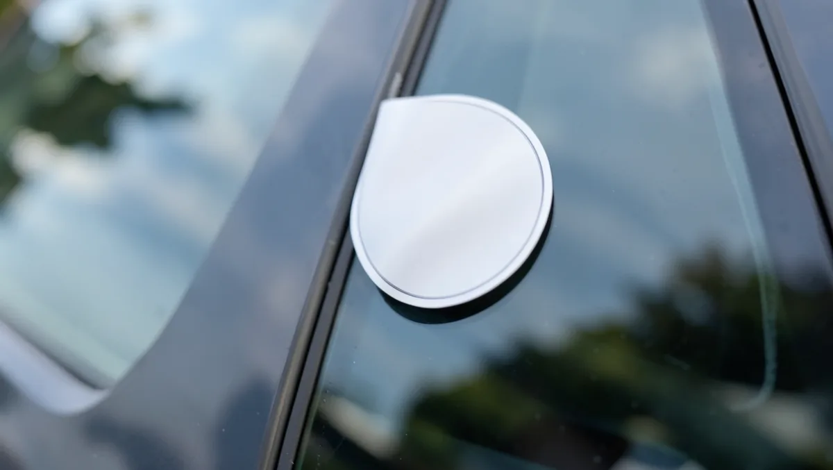 Removable vinyl decal peeling cleanly off a car window with no residue