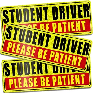 Student driver magnet sign warning other drivers while practicing a manual car