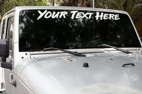 VulgrCo custom windshield sticker reading YOUR TEXT HERE on a white Jeep Wrangler windshield