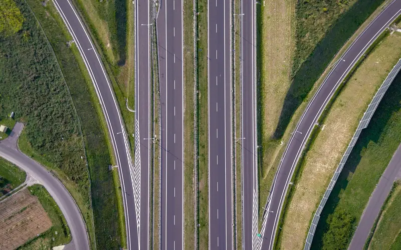 Aerial view of a multi-lane divided highway with dashed white lane markings