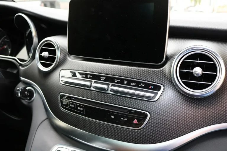 Car dashboard with an infotainment screen and radio and media buttons