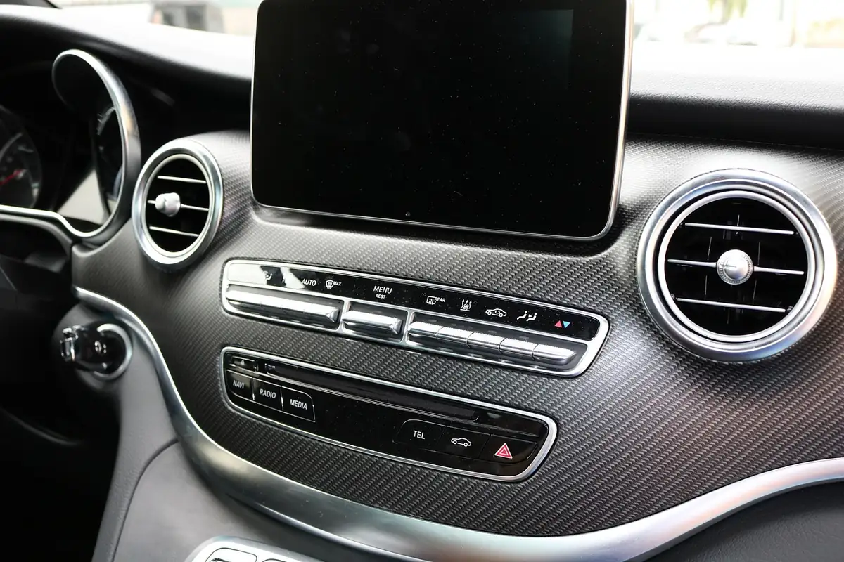 Car dashboard with an infotainment screen and radio and media buttons