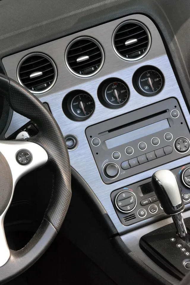 Round dashboard air vents and climate control buttons in a car interior