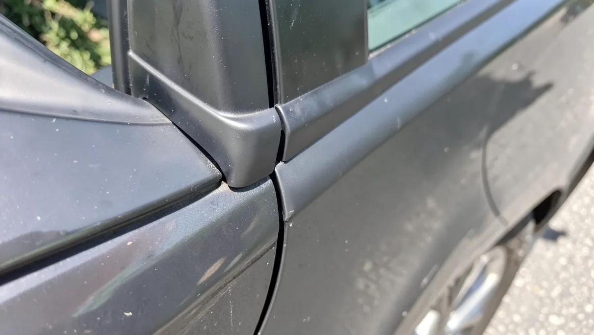 Close-up of a car door rubber weatherstrip and window seal
