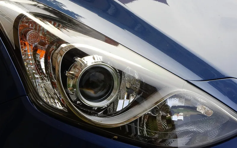 Close-up of a clear projector-style car headlight lens