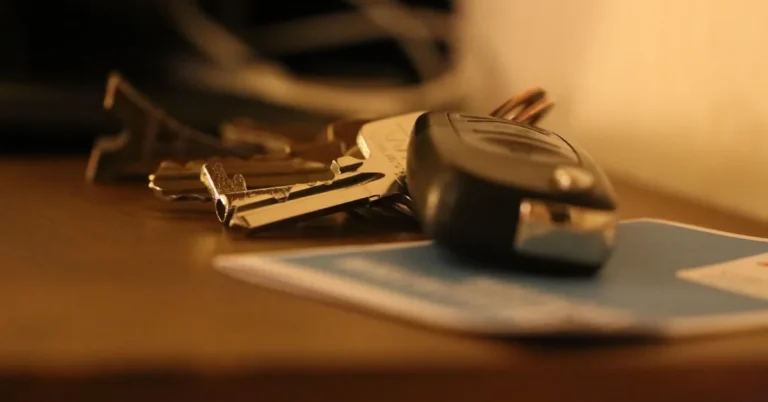 Car key fob and a set of keys resting on a wooden table