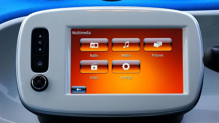 Car multimedia touchscreen showing radio, media, pictures and video menu