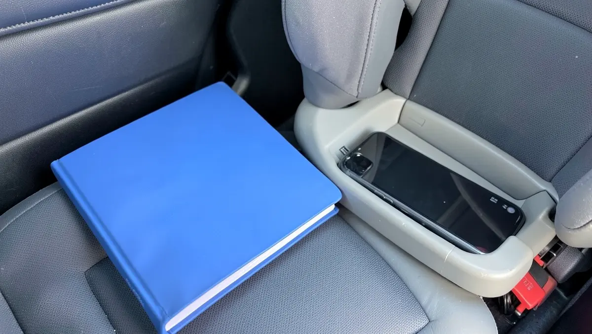 Insurance claim folder and phone used to document a car seat replacement claim after an accident