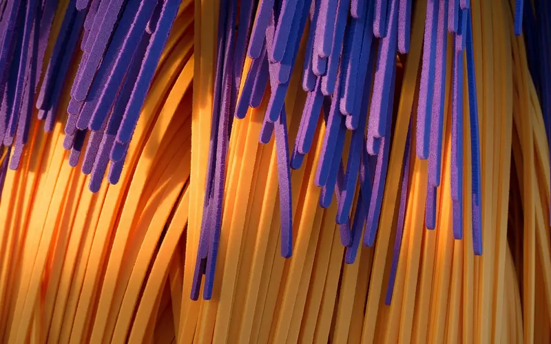 Close-up of orange and purple car wash brush bristles