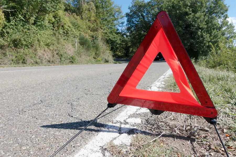Red warning triangle set on the edge of a road