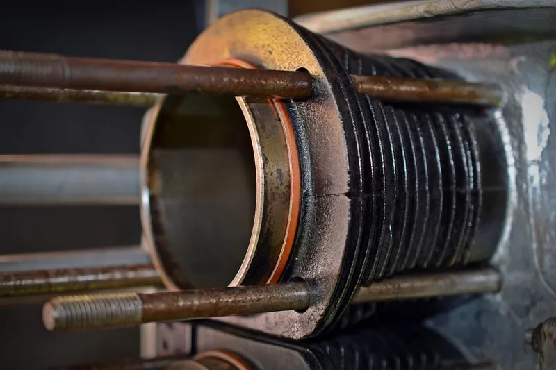 Close view of an exposed engine cylinder barrel held in place by long studs