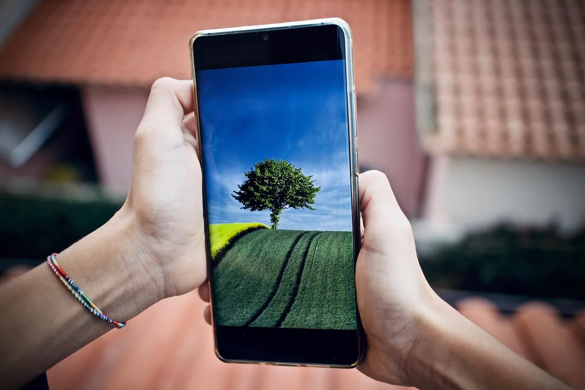 Two hands holding a smartphone upright