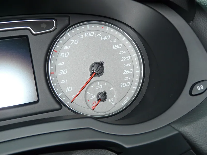 Instrument cluster with a small fuel gauge dial marked 1/2 and 1/1 with a red reserve mark