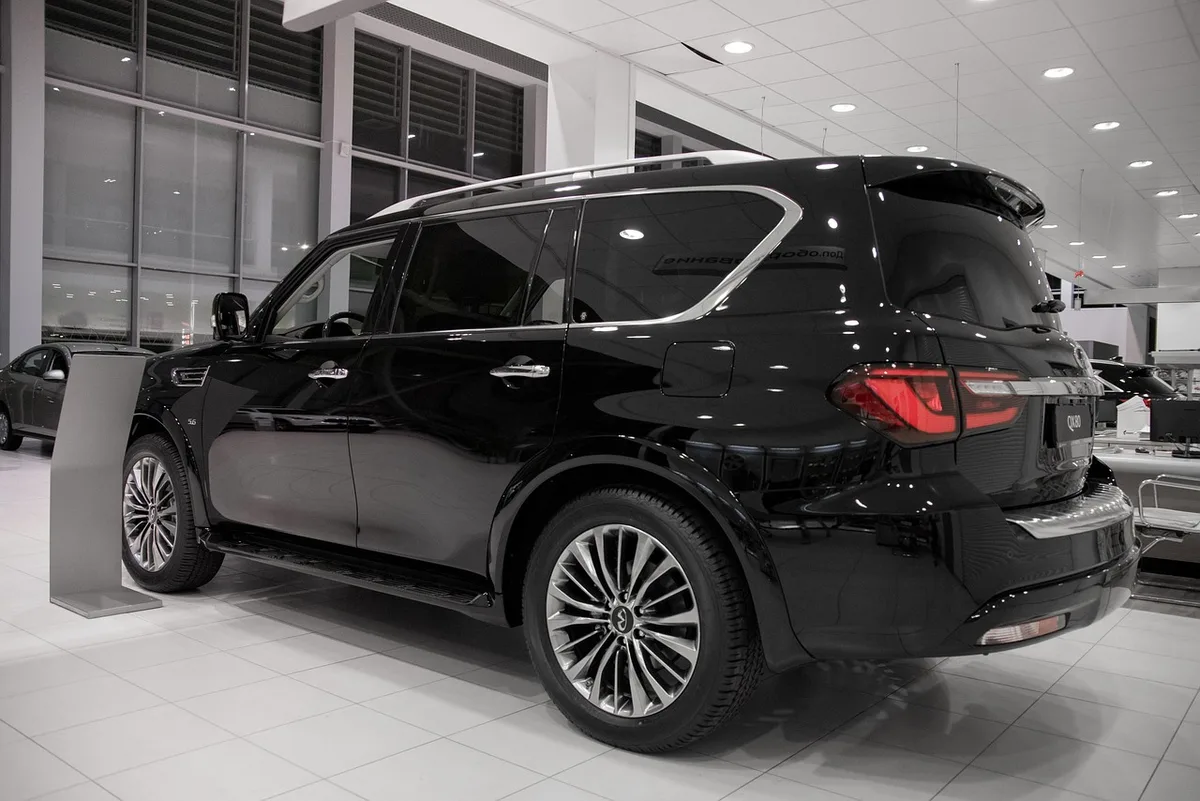 Dark SUV parked on a dealership showroom floor