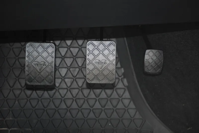 Three pedals in a manual transmission car: clutch on the far left, brake in the middle, and accelerator on the right
