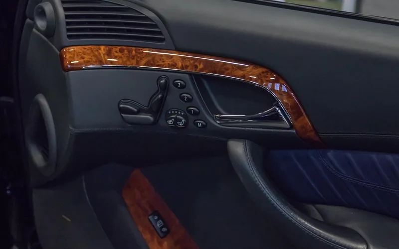 Power seat adjustment buttons on a car door panel used to set and save memory positions Power seat adjustment buttons on a car door panel used to set and save memory positions