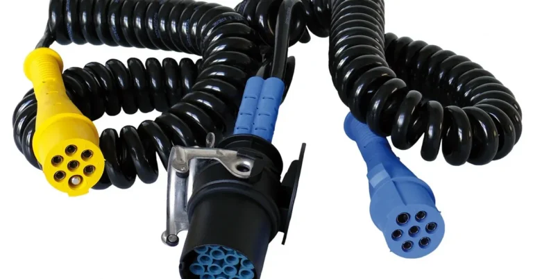 Multi-pin yellow, blue and black plug connectors on coiled black cables