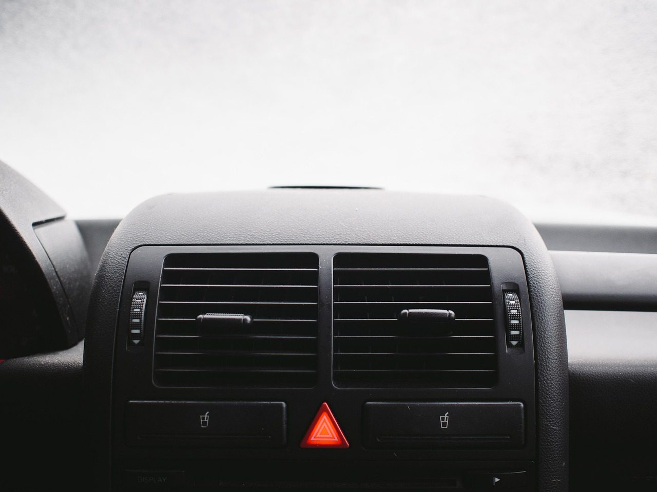 A car dashboard control panel showing warning light indicators