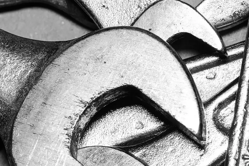 Pile of open-end wrenches in black and white