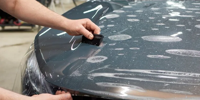 Professional detailer buffing a car's clear coat after superglue removal Professional detailer buffing a car's clear coat after superglue removal