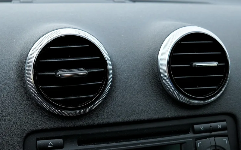 Two round dashboard air vents on a car dash