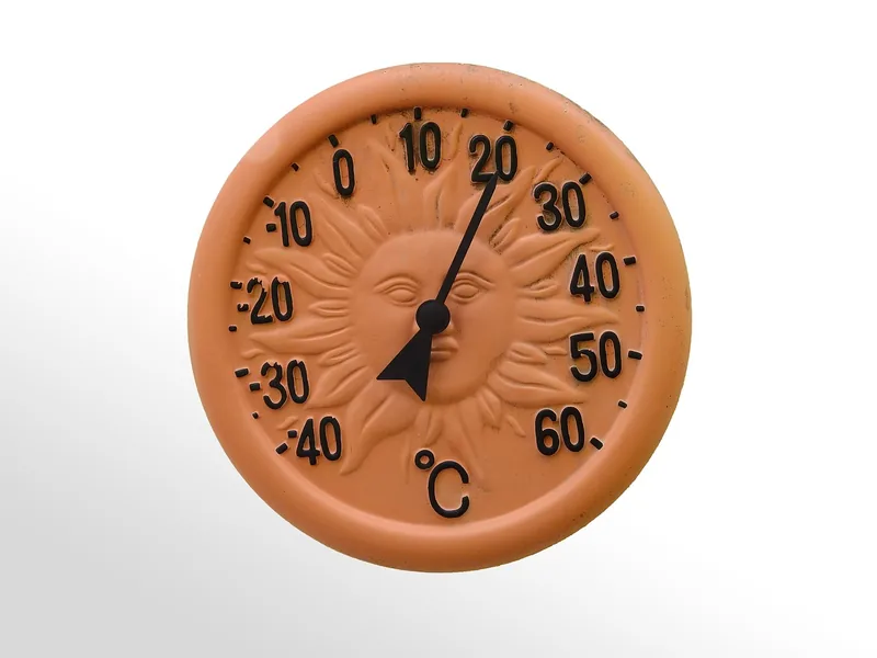Round dial thermometer face with a needle and a Celsius scale