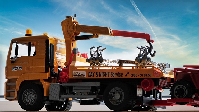 A tow truck loading a car onto its flatbed, the situation drivers face before locating their vehicle at an impound lot