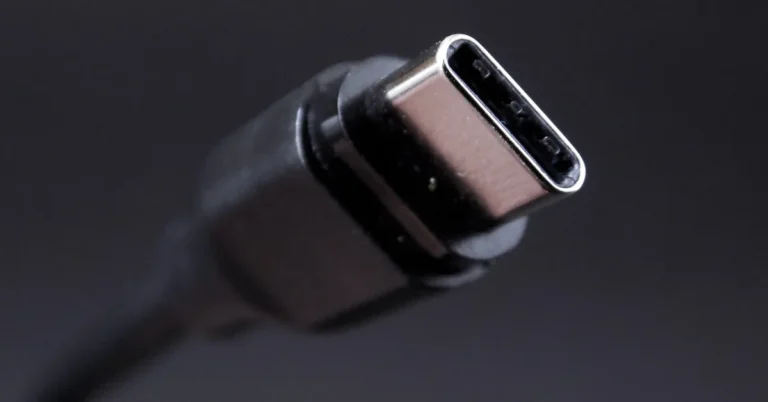 A USB-C connector on a cable photographed close up against a dark background