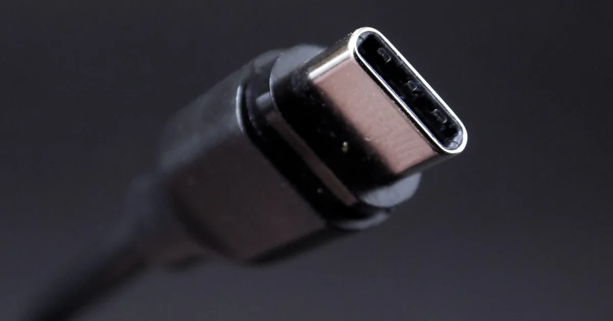 A USB-C connector on a cable photographed close up against a dark background