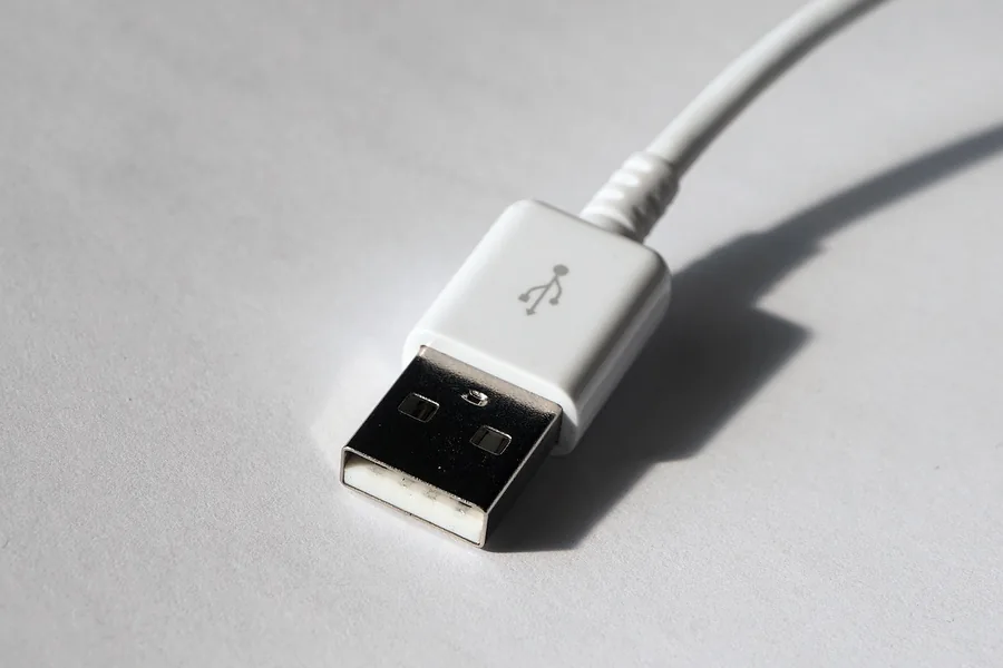White USB cable plug on a plain surface