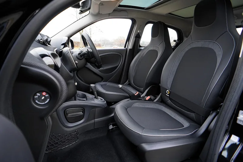 Car cabin with the roof lining and sunroof opening above the front seats