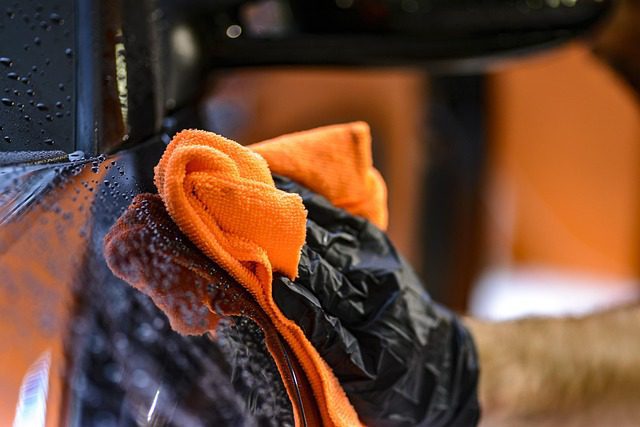 Microfiber cloth and cleaning supplies used to remove tire marks from car paint